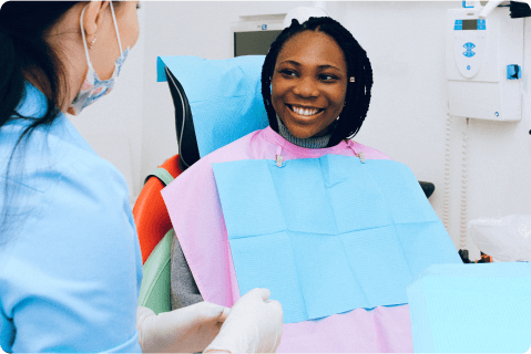 Satisfied patient sitting in dentist chair.